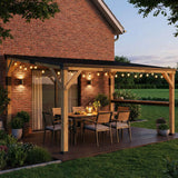 NatureScape Living's 10x14 Lean-To Gazebo with a wooden pergola, steel roof, and bar shelf on a deck with string lights at dusk.