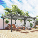 A 12x20 dark gray wood pergola from NatureScape Living shades an elegant outdoor lounge set on a sunny deck, surrounded by green trees.