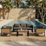 A NatureScape Living 4-piece aluminum frame outdoor sofa set with dark grey cushions and wood details, on a rug by a pool.
