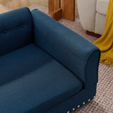 An oversized, elegant, modern blue linen dog sofa bed with a tufted back and silver decorative studs.