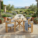 A NatureScape Living 5-piece acacia wood round patio dining set with gray cushions on a sunlit outdoor patio.