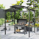 A black metal Premium Outdoor Grill Gazebo from NatureScape Living with a corrugated roof covers a grill, food, and firewood on a patio.
