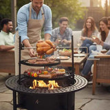 A man cooks a rotisserie chicken and meats on a wood-burning NatureScape Living 33 Inch Fire Pit with Grill for guests.