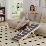 A beagle puppy walks up a gray and white striped NatureScape Living Foldable Pet Ramp for Couch, towards a woman relaxing on a cream sofa.