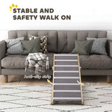 A NatureScape Living foldable pet ramp with wooden sides and grey carpeted anti-slip strips, leading to a couch.