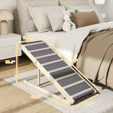 NatureScape Living's adjustable foldable pet ramp, featuring a light wood frame and grey steps, helps dogs access a bed.