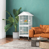 NatureScape Living's white 67" high Metal Bird Cage with Rolling Stand, housing two lovebirds in a modern teal-walled living room.
