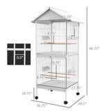 NatureScape Living's 67" high white metal bird cage feeder with a rolling stand, featuring two tiers, perches, and 0.5" bar spacing.