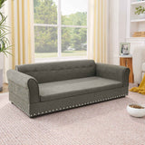 An elegant dark grey linen fabric oversized pet sofa bed with studded trim sits on a light rug in a sunny living room.