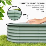 A NatureScape Living green corrugated raised garden bed featuring a safety rubber edging to protect fingers, shown on grass.