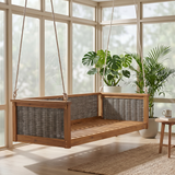 The TOPMAX Acacia Wood Swing Bed, made of light brown wood with gray woven panels, is suspended in a bright room with plants.