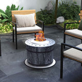 NatureScape Living's Smokeless Fire Pit with a black wood-grain magnesium oxide base and bright flames sits on a patio with outdoor chairs.