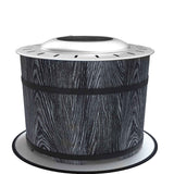 NatureScape Living's black wood grain smokeless fire pit with a silver top and black bands rests on its round mat.