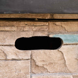 Close-up of a NatureScape Living 32 Inch Square Fire Pit's faux stone base with a dark horizontal access slot.