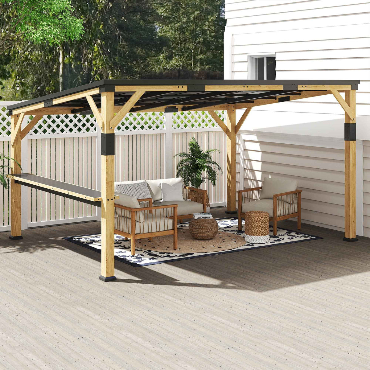 A 10x14 NatureScape Living Lean-To Gazebo with a steel roof and bar shelf shades a stylish outdoor lounge area on a deck.