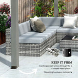 A NatureScape Living 12x20 Wood Pergola post, kept firm by L-shaped metal plates, stands by a grey wicker patio sectional.