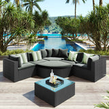 This Serenity Seating 7 Piece Wicker Sofa Set features black wicker, gray cushions, and striped pillows, set on a patio overlooking a pool and ocean.