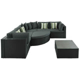 This luxurious 7 Piece Wicker Sofa Set features a black wicker L-sectional with gray cushions, striped pillows, and a coffee table.