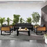 A NatureScape Living 4-piece dark grey aluminum frame outdoor sofa set with wood accents on an outdoor patio.