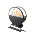 A sleek black round Subesta bioethanol fire pit with a glass screen displays warm flames, suitable for indoor or outdoor use.