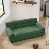 A green tufted Comfy Large Dog Sofa Bed, made of textured fabric, rests on a wooden floor with a pet food bowl.