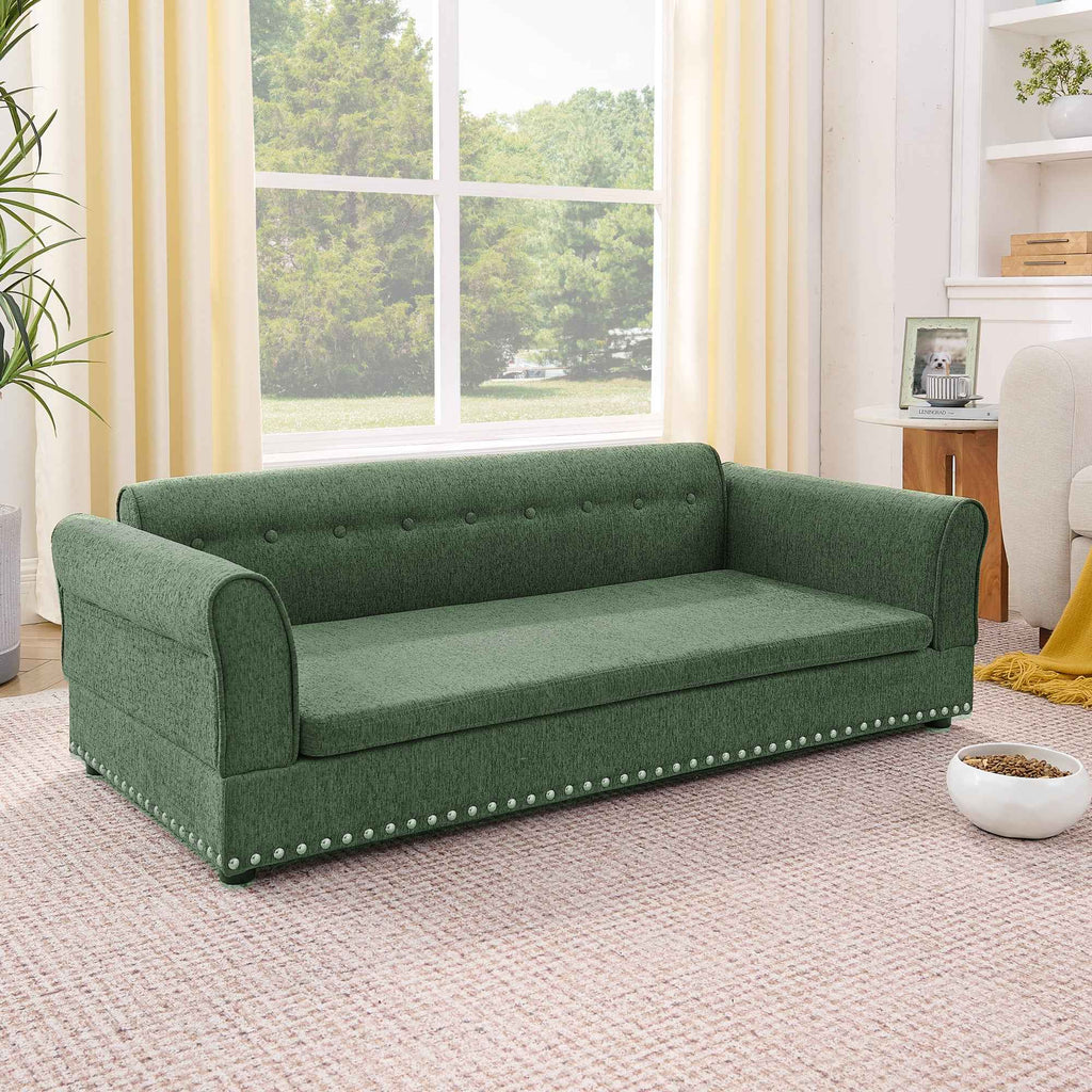 An elegant, modern oversized green linen dog sofa bed with a tufted back and silver nailhead trim.