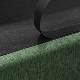 Close-up of a NatureScape Living dog sofa bed's ribbed dark green linen fabric with a black strap lifting a dark lining.