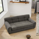 NatureScape Living's elegant dark gray tufted large dog sofa bed sits on a light wooden floor, with a pet food bowl nearby.