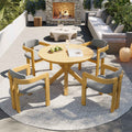 NatureScape Living's 5-piece acacia wood round patio dining set with gray cushions on a bright outdoor patio.