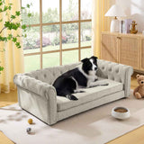 A Border Collie relaxes on a light grey, tufted Elegant Rectangular Elevated Dog Bed from NatureScape Living in a bright room.