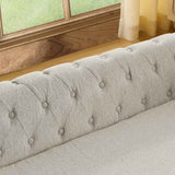 Elegant rectangular elevated dog bed featuring a light grey tufted back and buttons, set near a window.
