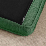 Corner of an Elevated Dog Bed cushion, featuring its textured green fabric, black zipper, and a beige carpet.
