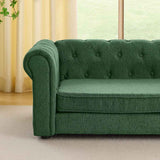 Elegant rectangular dark green elevated dog sofa for big dogs, featuring a tufted back and rolled arm, on a light carpet.
