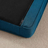 Close-up of an Elevated Dog Bed, showing its teal rectangular cushion with a visible black zipper on a beige rug.
