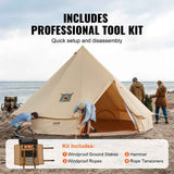 A NatureScape Living "Glamping Bell Tent" is set up on a sandy beach, with people assembling it and its included windproof tool kit.
