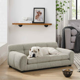 A white bulldog relaxes on the light grey NatureScape Living Luxurious Dog Sofa Bed with backrest and armrests in a living room.