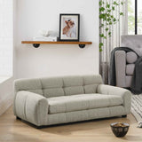 A luxurious, light grey tufted dog sofa bed with backrest and armrests on a wooden floor, with a pet food bowl nearby.