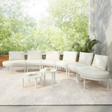 A beige TOPMAX 8-piece half moon outdoor patio sectional sofa with round tables on a textured rug in a lush garden setting.