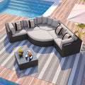 GO 7-piece brown rattan lounger with beige cushions and striped pillows on a striped rug by a pool.