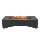 A modern dark gray rectangular gas fire pit table from NatureScape Living with a curved base, visible flames, and fire glass.