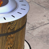 NatureScape Living's smokeless fire pit, featuring a natural wood-grain barrel, a brushed metal top, and a warm flame on a patio.