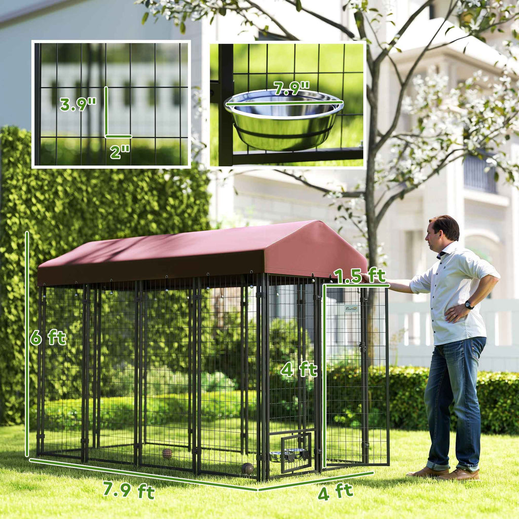 A spacious NatureScape Living walk-in dog kennel with a dark frame, maroon roof, and rotating bowl stands on grass.