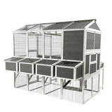 A NatureScape Living walk-in chicken coop with a run for 10 chickens, featuring dark gray panels, white trim, and multiple nesting boxes.