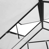 Interior view of a NatureScape Living walk-in greenhouse showing its black aluminum frame, white polycarbonate panels, and open roof vent.