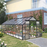 NatureScape Living's Walk-in Green House Kit, an aluminum and polycarbonate structure, filled with plants on a green lawn.