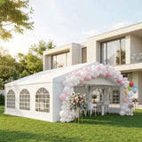 White Wedding Party Tent with arched window sidewalls, adorned with pink and white balloons on a green lawn.