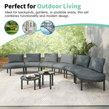 A grey TOPMAX 8-Piece Half Moon Wicker Rattan Sectional Sofa Set and two round tables are arranged on an outdoor patio.