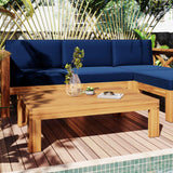 A TOPMAX Wood Patio Sectional 5-piece outdoor sofa set with navy blue cushions and a matching coffee table on a deck by a pool.
