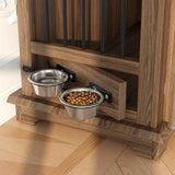 A brown wooden dog kennel with black bars, featuring two attached stainless steel food and water bowls.